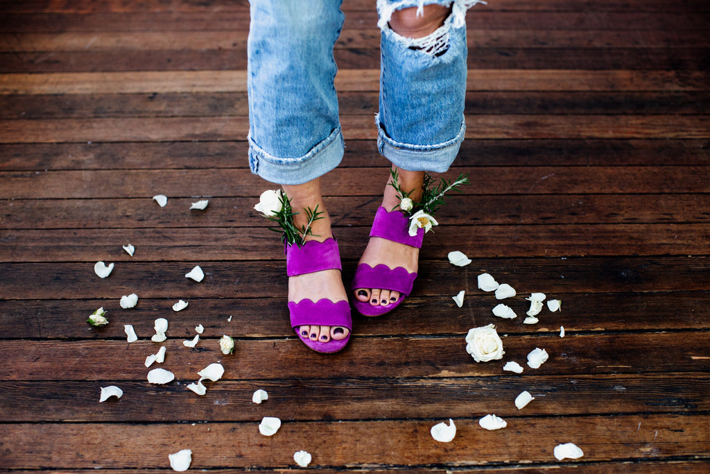 Women with new pedicure standing around rose petals