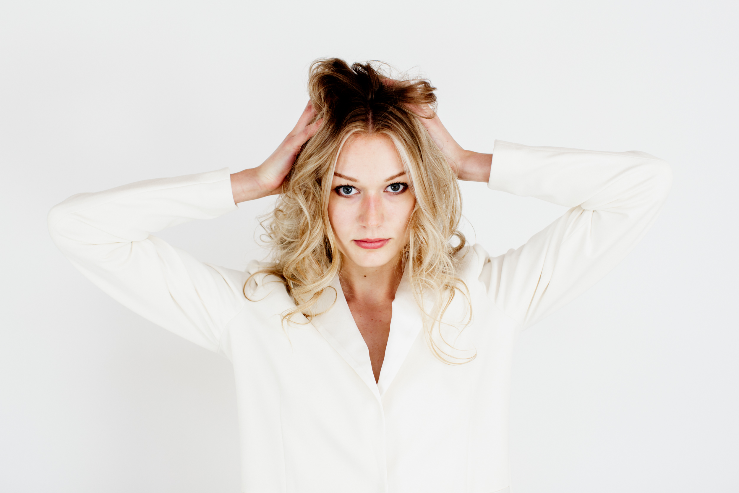 Woman wearing a white shirt and blonde hair. 