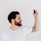 man is holding a volumizing powder for his hair